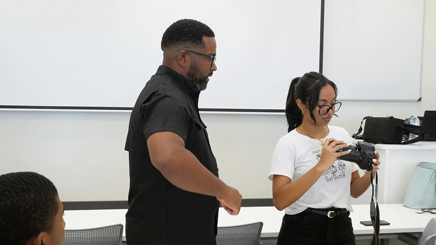 Docente, y estudiante revisan la configuración de la cámara. 